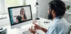 a man talking to another man on a computer