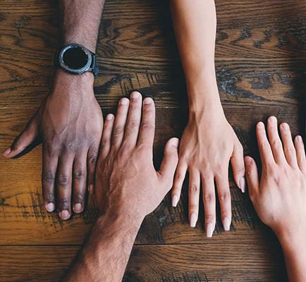 4 different colored hands on a table