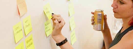 A woman holding a soda while brainstorming