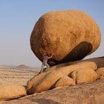Man moving a giant boulder