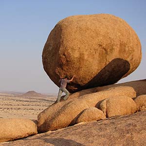 Man moving a giant boulder