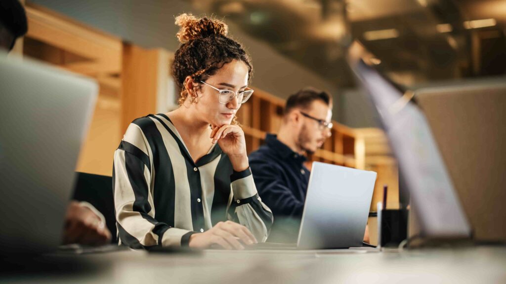 person in an office environment reading looking at computer laptop screen learning, what is vdi
