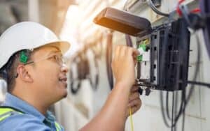 telecommunications professional works to replace legacy services with fiber, 5G, or satellite last-mile technologies